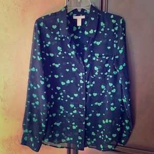 A heart dotted see through button down shirt